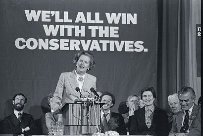 British prime minister candidate Margaret Thatcher speaks at a podium in an arena during the 1979 parliamentary election. Thatcher, representing the Conservative Party, would become the first female Prime Minister in Europe and would serve three consecutive terms. (Photo by Owen Franken/Corbis via Getty Images)