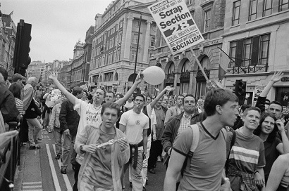 Marchers at the Lesbian, Gay, Bisexual, and Transgender Pride event, Piccadilly, London, 4th July 1998. One marcher is holding a Socialist Worker placard, calling for the scrapping of Section 28, which refers to an amendment to the Local Government Act 1988 forbidding the 'promotion' of homosexuality by local authorities. (Photo by Steve Eason/Hulton Archive/Getty Images)