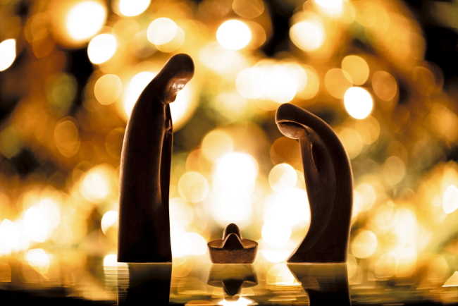 Christmas. Wooden crib with lights background.